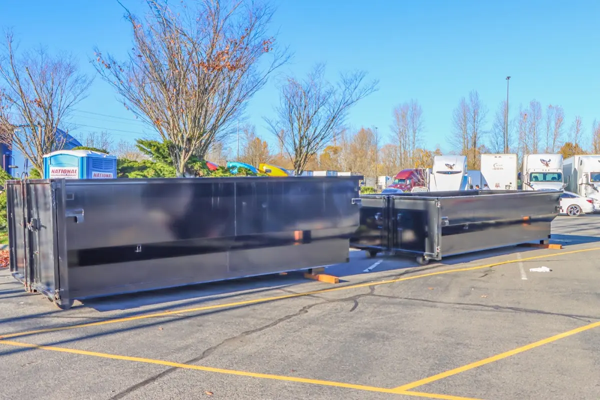 Professional dumpster rental service with roll-off container on residential driveway in Homestead Meadows South